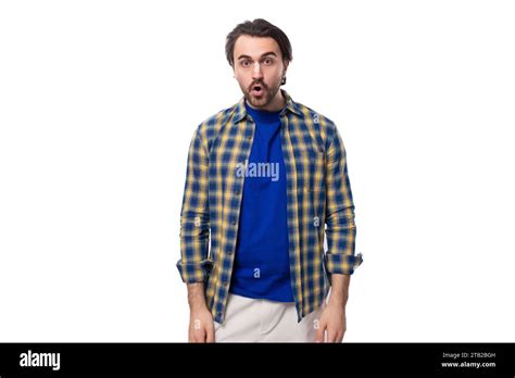 Well Groomed Brunette Brutal Man With A Beard In A Plaid Shirt On A