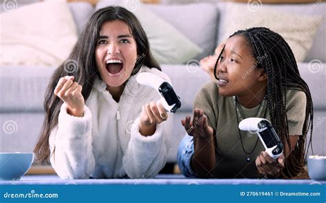 Celebrate Controller And Friends Playing A Game In The Living Room For