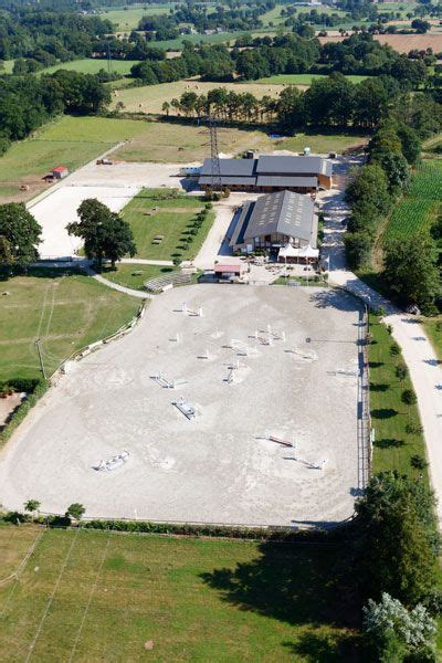 An Aerial View Of A Large Building In The Middle Of A Field