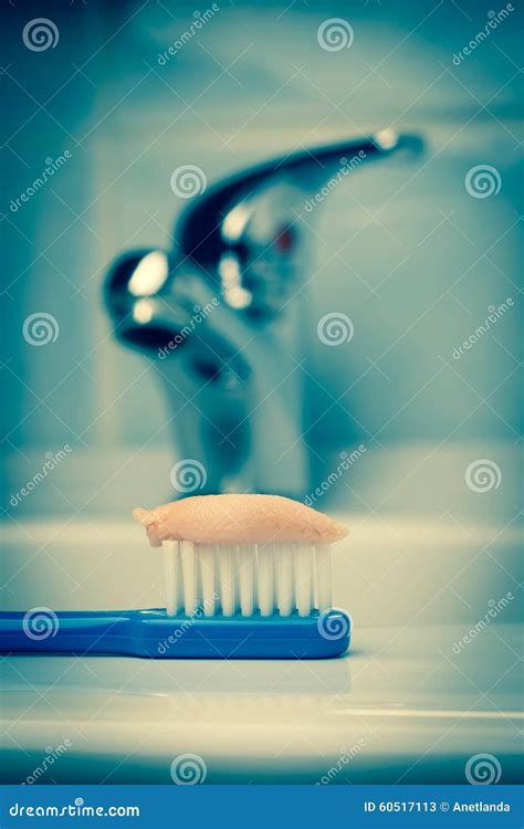 Blue Toothbrush With Paste In Bathroom On Sink Stock Image Image Of