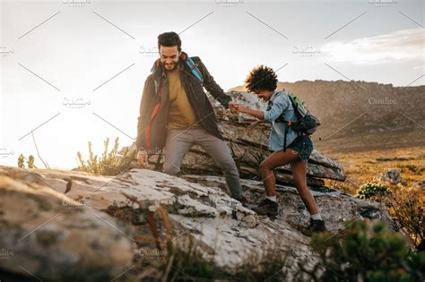 Young Couple Hiking In Nature Containing Adventure Boyfriend And Climbing High Quality