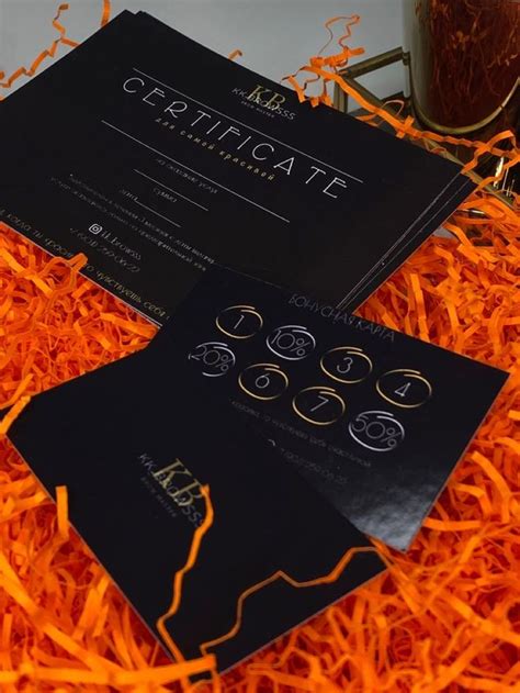 Two Black Cards Sitting On Top Of Orange Shredded Paper