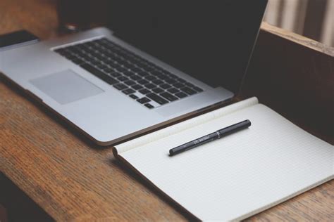 Laptop Notepad Pen On Desk Royalty Free Stock Photo