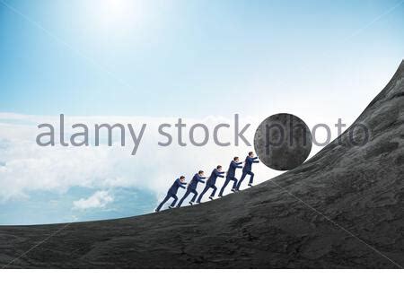 The Team Of People Pushing Stone Uphill Stock Photo Alamy