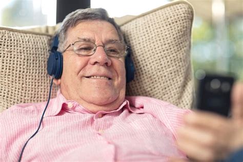 Premium Photo Smiling Senior Man Wearing Headphones Listening To