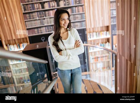 Beautiful Brunette Posing In Library Stock Photo Alamy