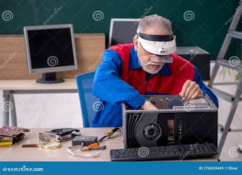 Old Repairman Repairing Computers In The Classroom Stock Image Image