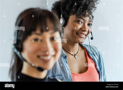 Businesswomen Wearing Headset Stock Photo Alamy