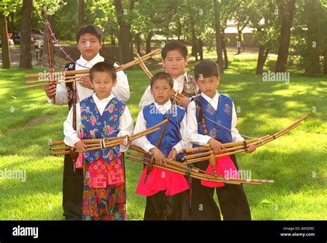 Hmong musicians age 12 holding traditional Hmong musical instrument at Taste of Frogtown ...