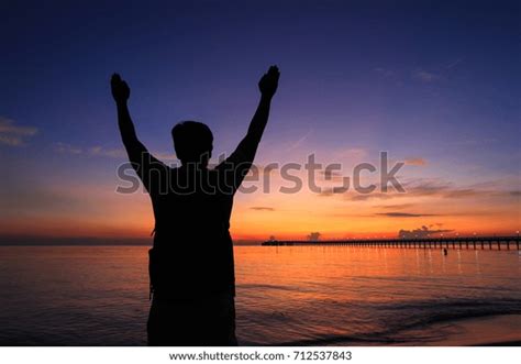 Silhouette Man Hands Raised Beautiful Sunrise Stock Photo 712537843