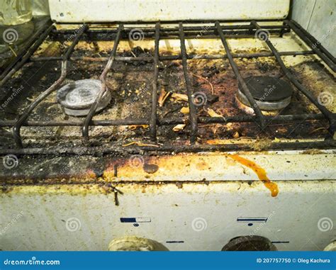 Dirty And Rusty Top Of A Kitchen Gas Stove With Pieces Of Debris Food