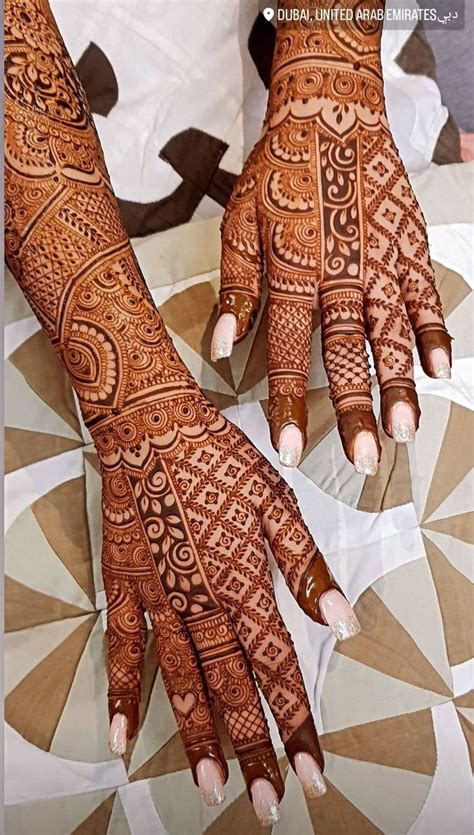 Two Hands With Henna Designs On Them