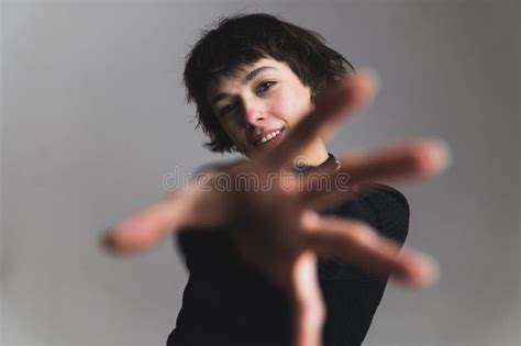 Blurred Foreground Woman Reaching Forward With Her Hand Medium Shot