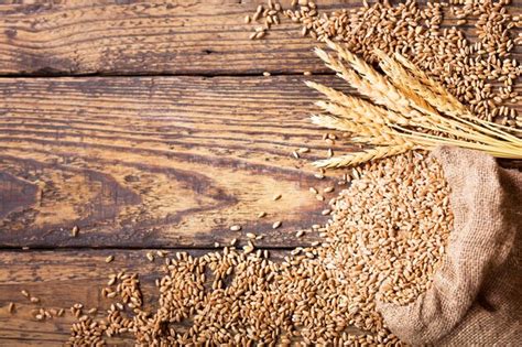 Premium Photo Wheat Grains In Sack On Wooden Table