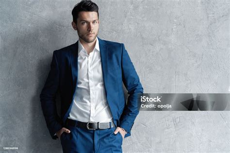 Handsome Man Wear Blue Suit Isolated On Grey Background Stock Photo