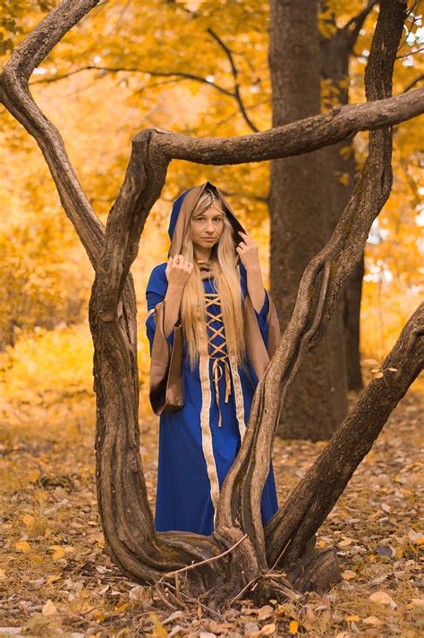 Royalty Free Photo Woman Wearing Blue And Gold Dress Standing Beside