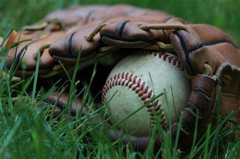 Premium Photo Close Up Of Baseball And Glove On Grass