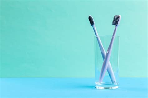 Premium Photo Toothbrushes In Glass