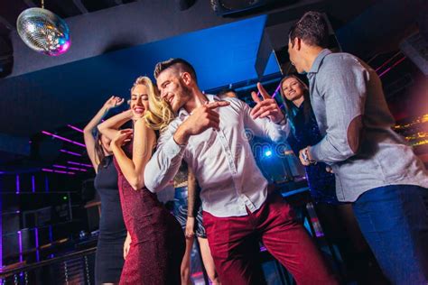 Friends Partying in a Nightclub Stock Image - Image of adult, attractive: 148120675