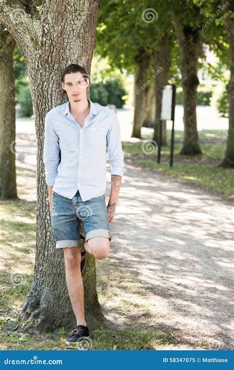 Man Outdoors Leaning On A Tree Stock Image Image Of Positive Park