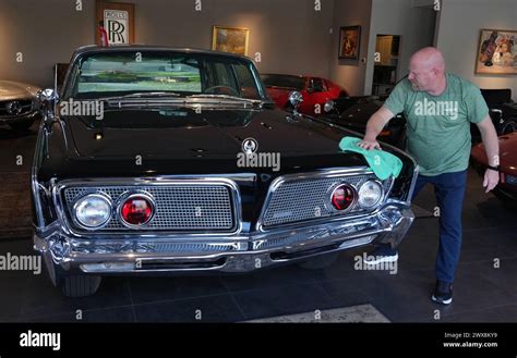 A Worker Wipes Down The Imperial Crown Presidential Limo In The