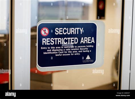 A Security Sign At An Airport Terminal Warns Of A Restricted Area Stock