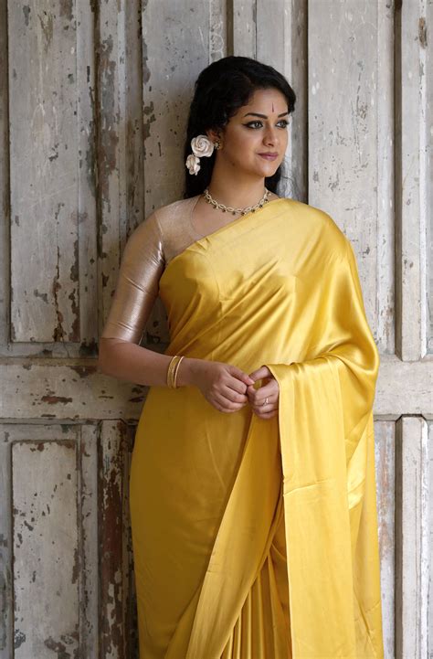 Download Keerthi Suresh Enchanting In A Golden Yellow Saree Wallpaper