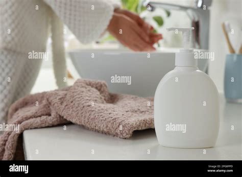 Woman Washing Hands With Liquid Soap In Bathroom Focus On Dispenser