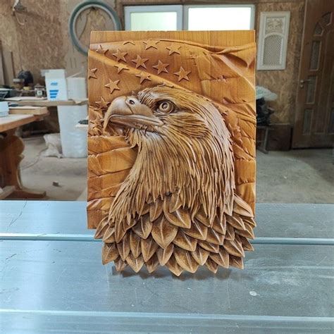 An Eagle Head Carved Into Wood On Top Of A Table