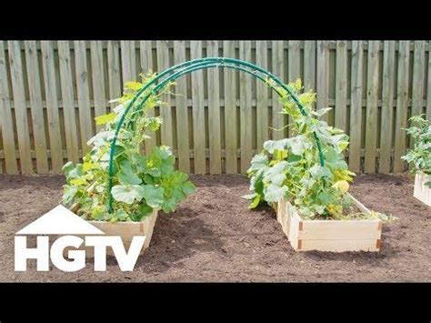 Three Wooden Planters With Plants Growing In Them On The Ground Next To