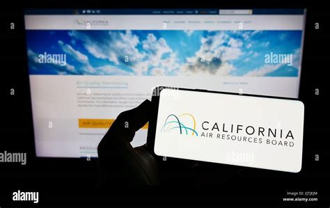 Person Holding Mobile Phone With Logo Of California Air Resources Board