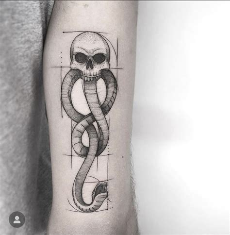 A Skull And Snake Tattoo On The Arm