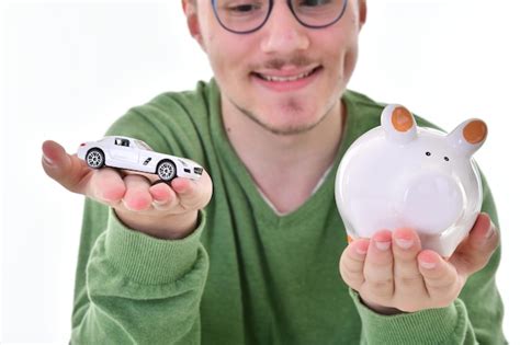 Premium Photo Man Holding Piggy Bank And Toy Car