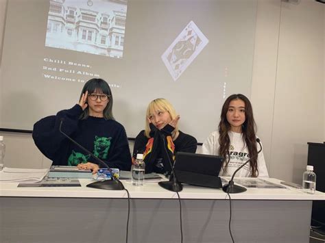 Three Women Sitting At A Table With Laptops And Microphones In Front Of