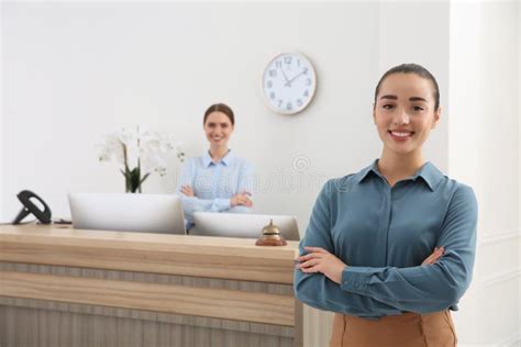 Portrait Of Beautiful Receptionist Near Counter In Hotel Stock Photo