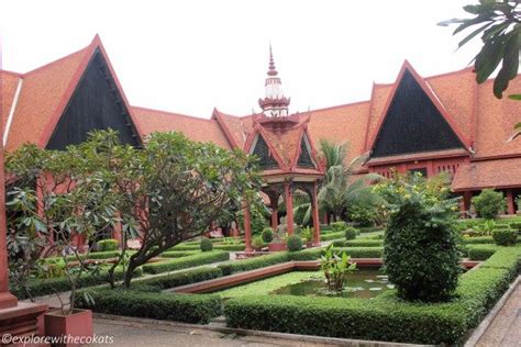 An Ornate Garden In Front Of A Red Building