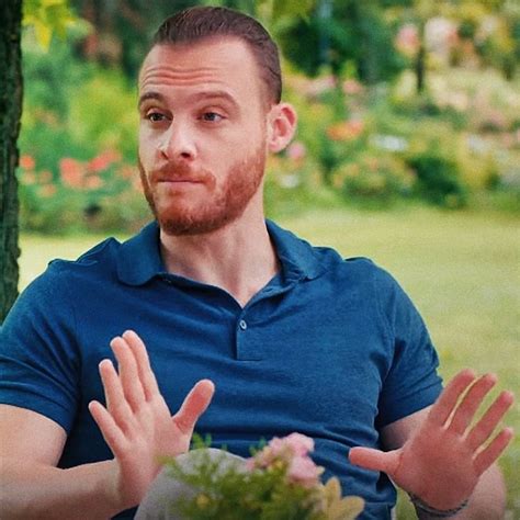 A Man Sitting In A Chair With His Hands Open