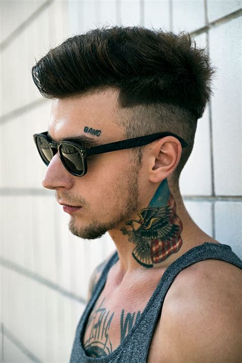 "Side View Of Tattooed Man In Sunglasses" by Stocksy Contributor "Danil Nevsky" - Stocksy