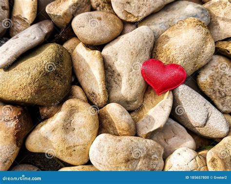 Closeup Of A Red Heart On Round Stones In The Rays Of The Sun Stock