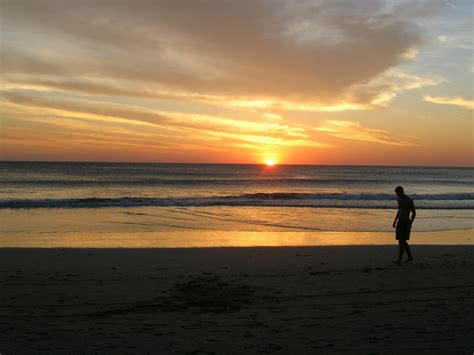 Silhouette Of Man Walking On Seashore During Sunset Free Image Peakpx