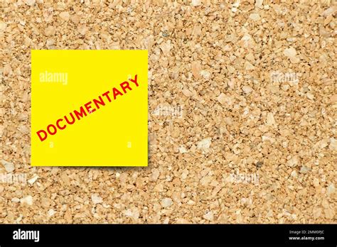 Yellow Note Paper With Word Documentary On Cork Board Background With