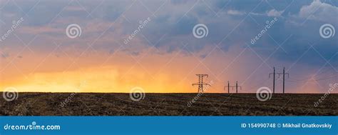 Epic Sunset With Rural Landscape With High Voltage Line Stock Photo