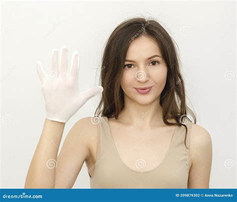 Young Woman Brunette Wears A White Glove For Hygiene Stock Photo