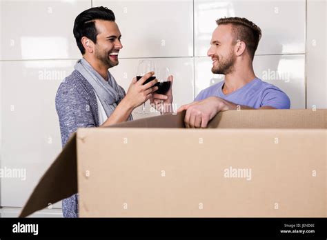 Smiling Gay Couple Drinking Red Wine Stock Photo Alamy