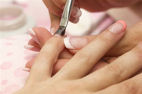 Download A Woman Is Getting Her Nails Done At A Nail Salon