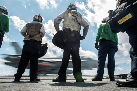 Sailors Watch As An Fa 18c Hornet Photograph By Stocktrek Images Pixels