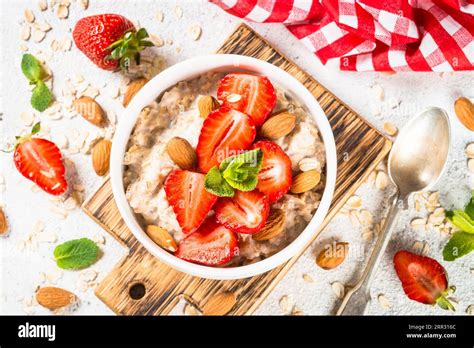 Oatmeal Porridge With Fresh Strawberry And Nuts On White Background