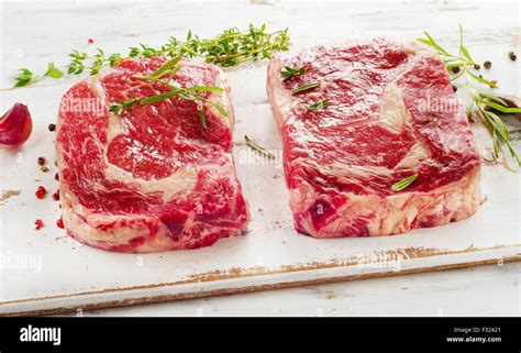 Raw Rib Eye Steaks On A Cutting Board Selective Focus Stock Photo Alamy