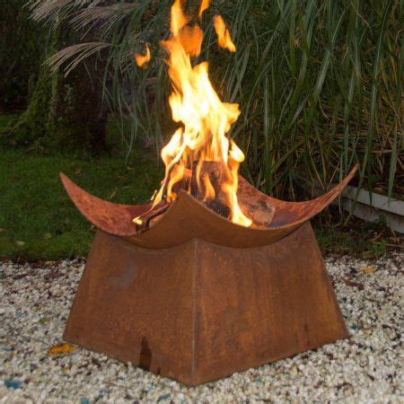 A Fire Pit Sitting On Top Of A Gravel Field