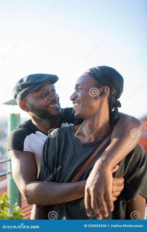 Portrait Of Romantic African Gay Couple Hugging For Photo Stock Photo